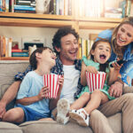 So many fun memories were made on family movie night. Shot of a happy family watching movies on the sofa at home.
